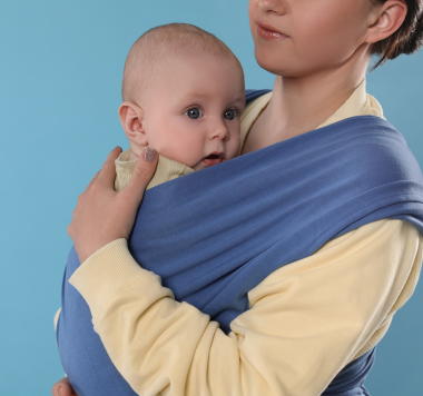 baby in sling carrier