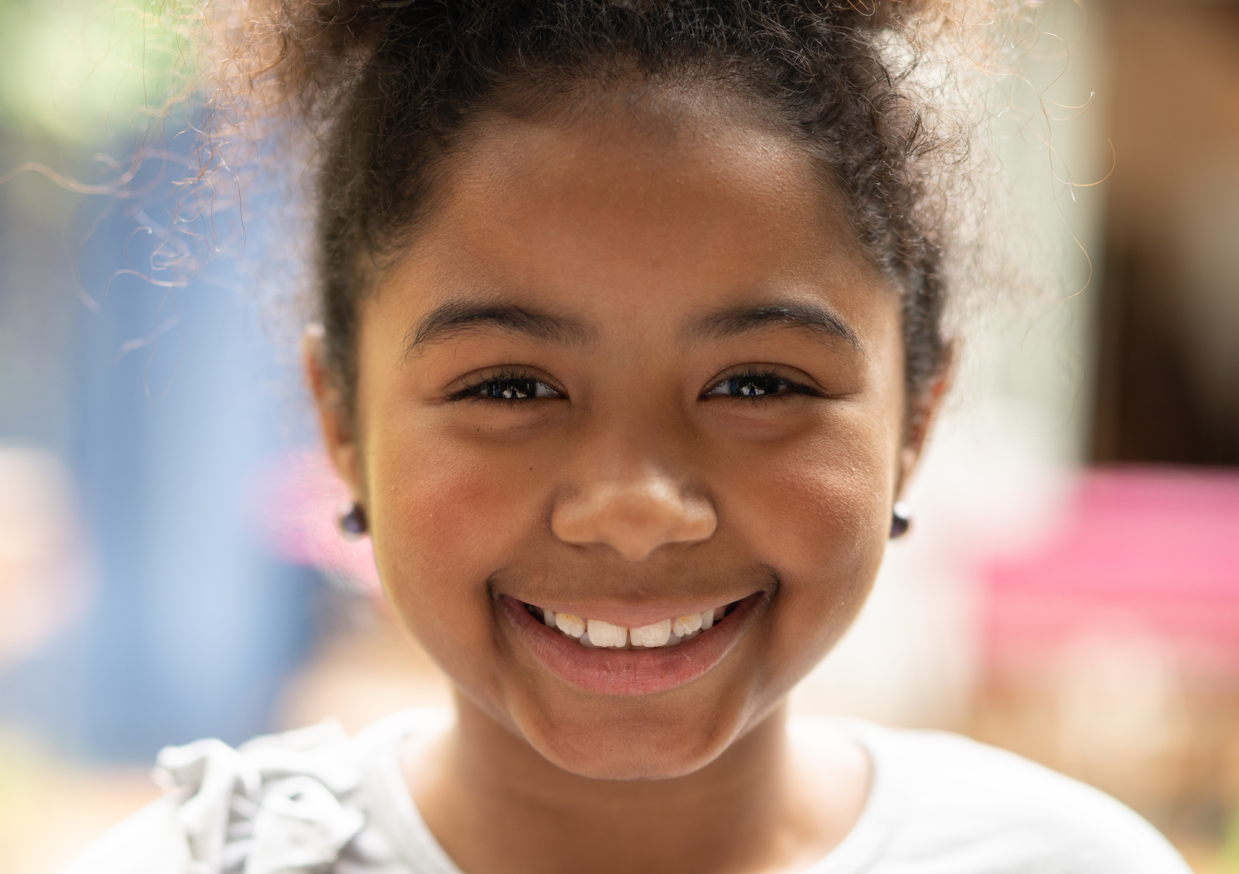 young girl smiling directly at the camera