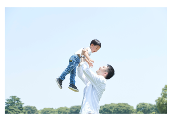 A adult holding a child in the air