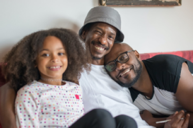 two dads with their daughter