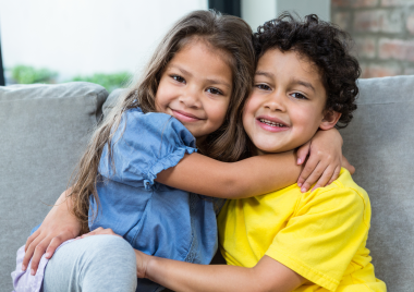 young boy and girl hugging