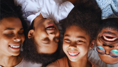 children lying on their backs smiling