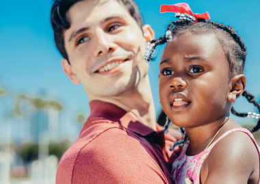 Little girl being carried by social worker