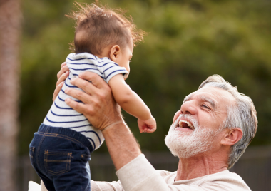 Grandfather holding baby boy
