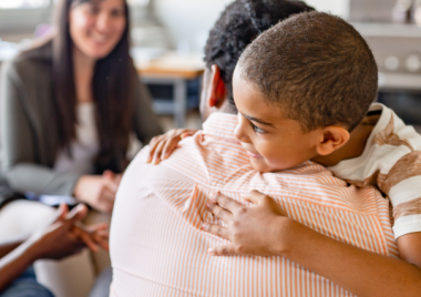 child hugging a man