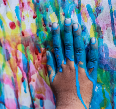 Child's right hand covered in blue paint