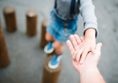 A child's hand holding an adults hand