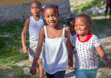 Three children walking and holding hands