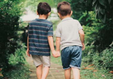 Two young boys holding hands