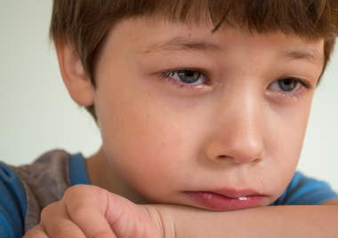 A young boy looking upset