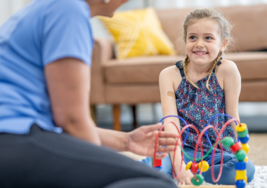 child smiling at an adult