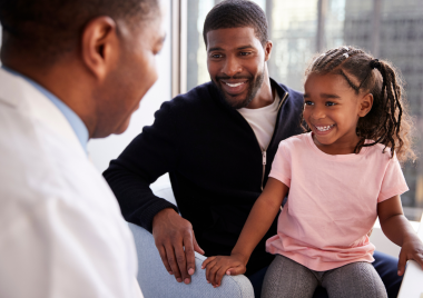 Parent and daughter speaking to a doctor