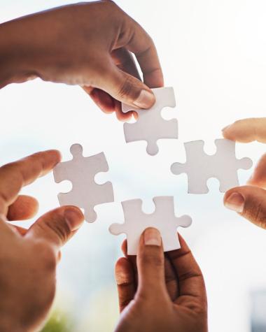 Hands holding jigsaw pieces