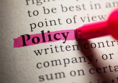 A book with the word policy highlighted